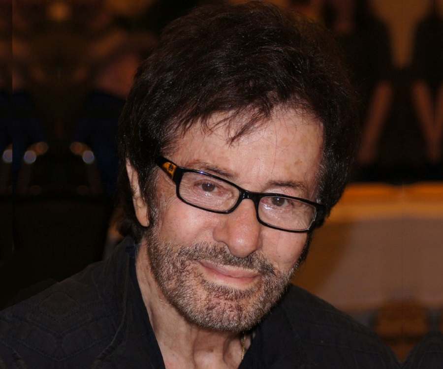 George Chakiris in his old  age posing for the picture wearing spectacles